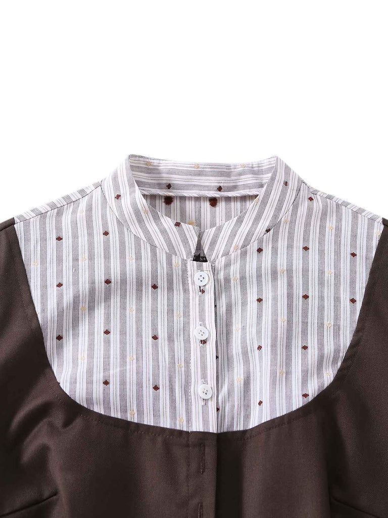Close-up of a brown garment with a white collar featuring small buttons and a subtle pattern.