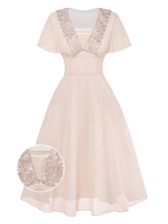 Beige dress with lace detailing on a white background