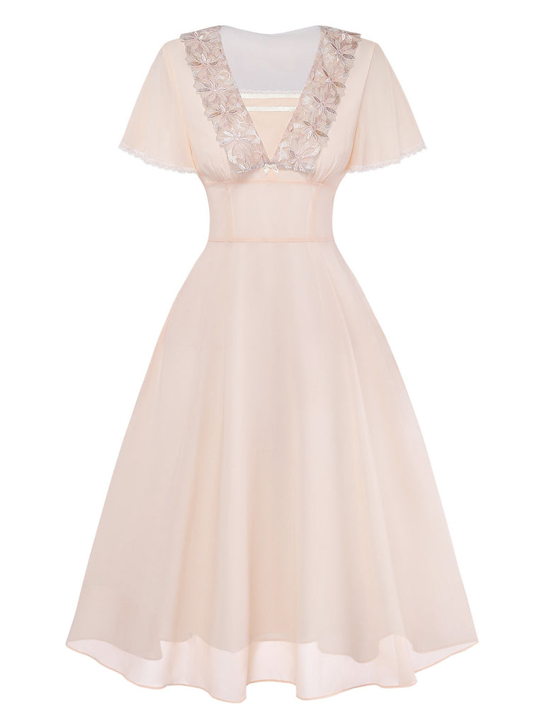 Blush pink dress with lace details on a white background