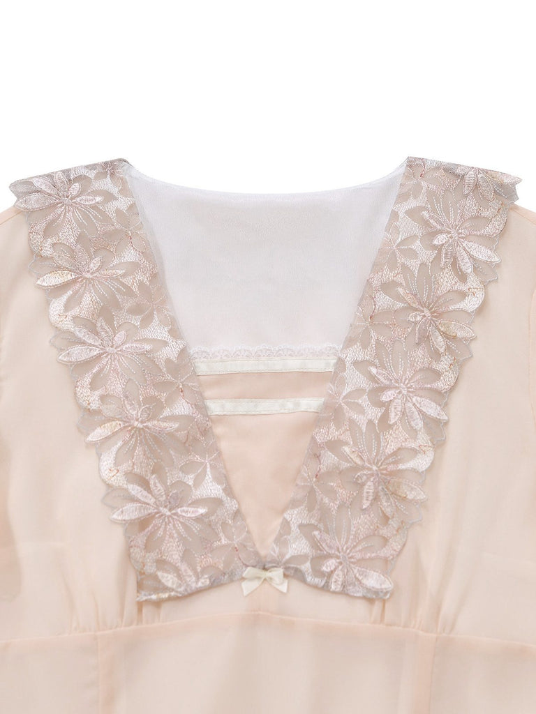 Close-up of a beige dress with floral lace details on a white background