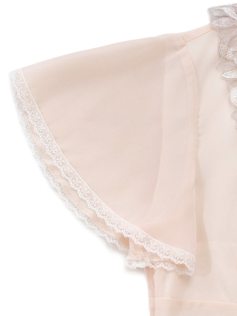 Close-up of a light pink fabric with lace trim on a white background