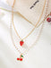 Necklace with strawberry and cherry charms on a white background