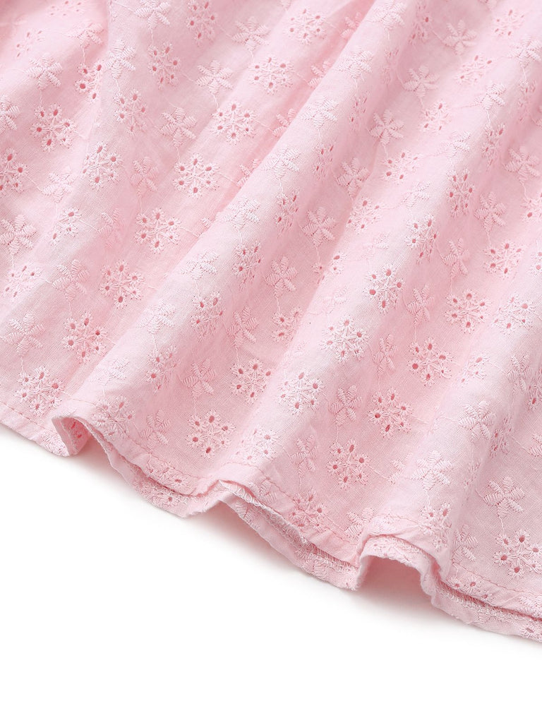 Close-up of pink fabric with a subtle pattern on a white background