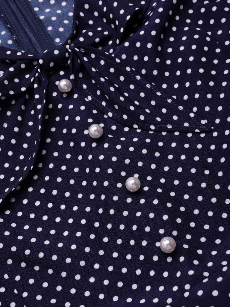 Navy blue dress with white polka dots and pearl buttons