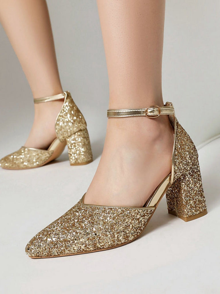 Gold glitter high heels on a neutral background