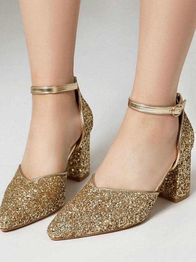 Gold glitter high heels on a neutral background