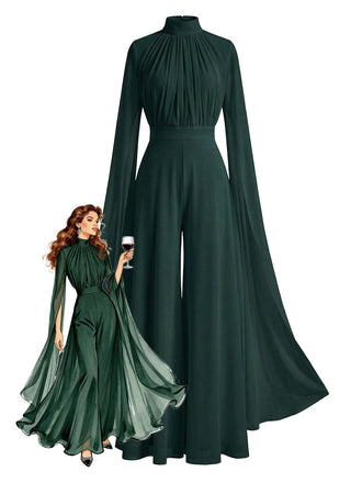 Green evening gown with long sleeves and a cape-like feature, worn by a model holding a glass of wine.