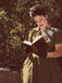 She slips into this Green 1940s Lapel Buttoned Solid Dress and suddenly it's a 1940s daydream