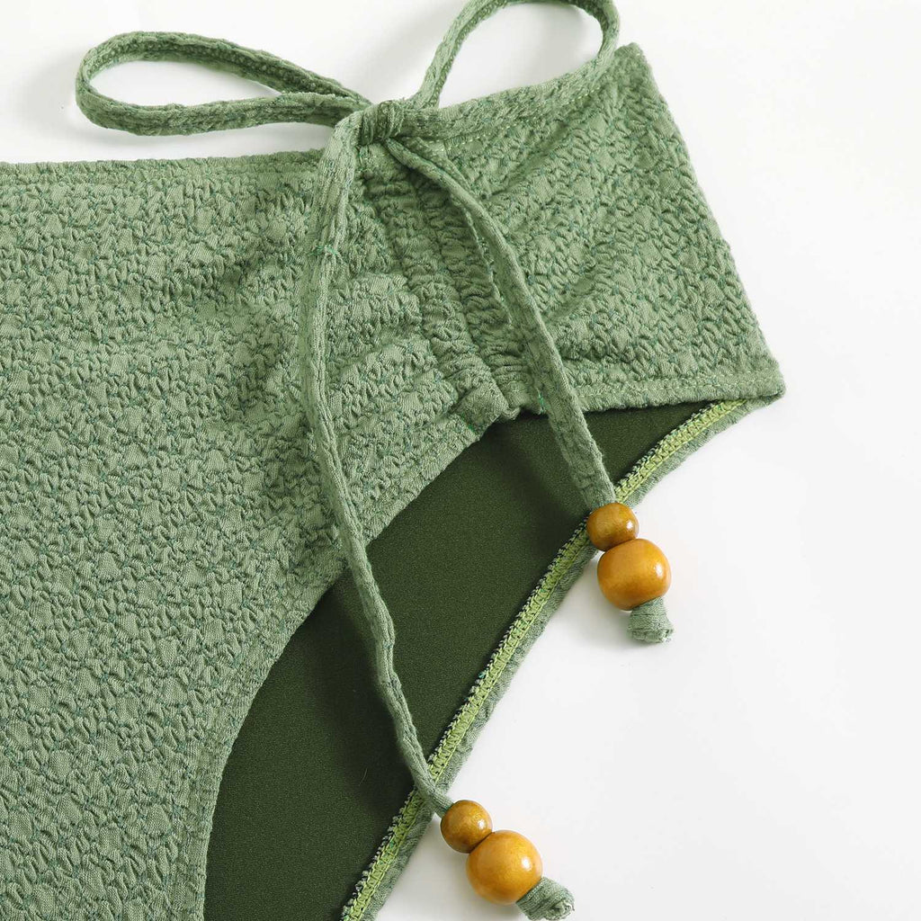 She's wearing Green 1970s Boho Beaded Bikini Set & Ruched Cover-Up and the whole beach remembers the 1970s