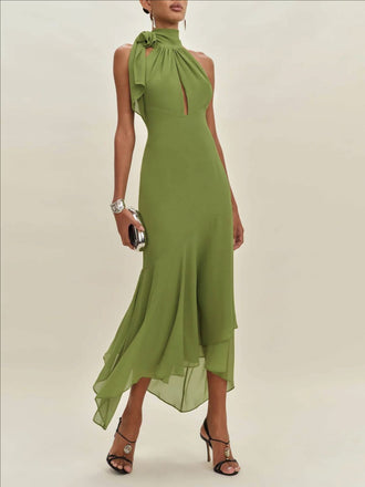 Green dress with a high neckline and ruffled details on a plain background