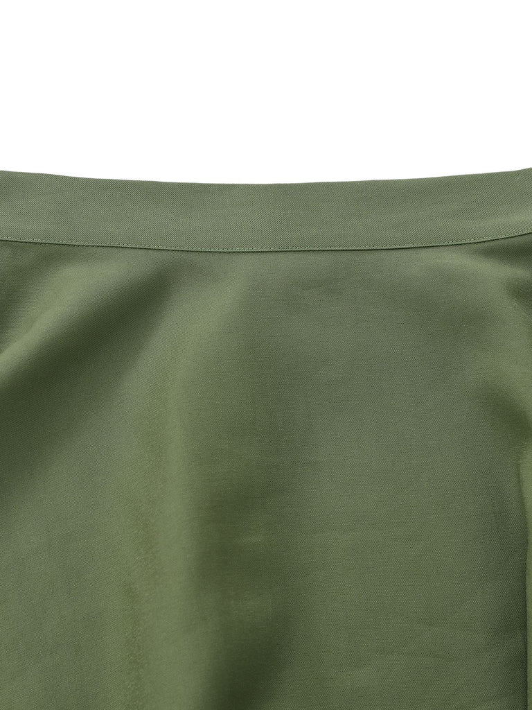 Close-up of green fabric with a visible seam on a white background