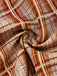 Close-up of plaid fabric with brown and beige colors