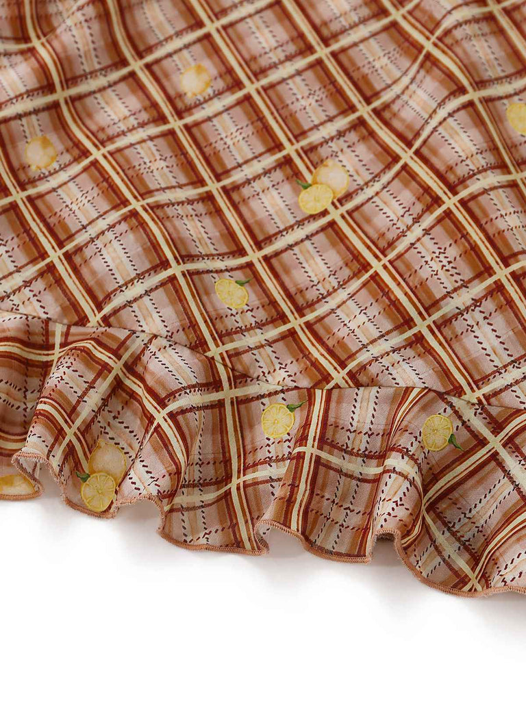 Close-up of a plaid fabric with lemon patterns on a white background