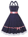 She slips into this Navy Blue 1950s Polka Dot Halter Dress and suddenly it's a 1950s daydream