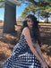 She slips into this Navy Blue 1950s Polka Dot Halter Dress and suddenly it's a 1950s daydream