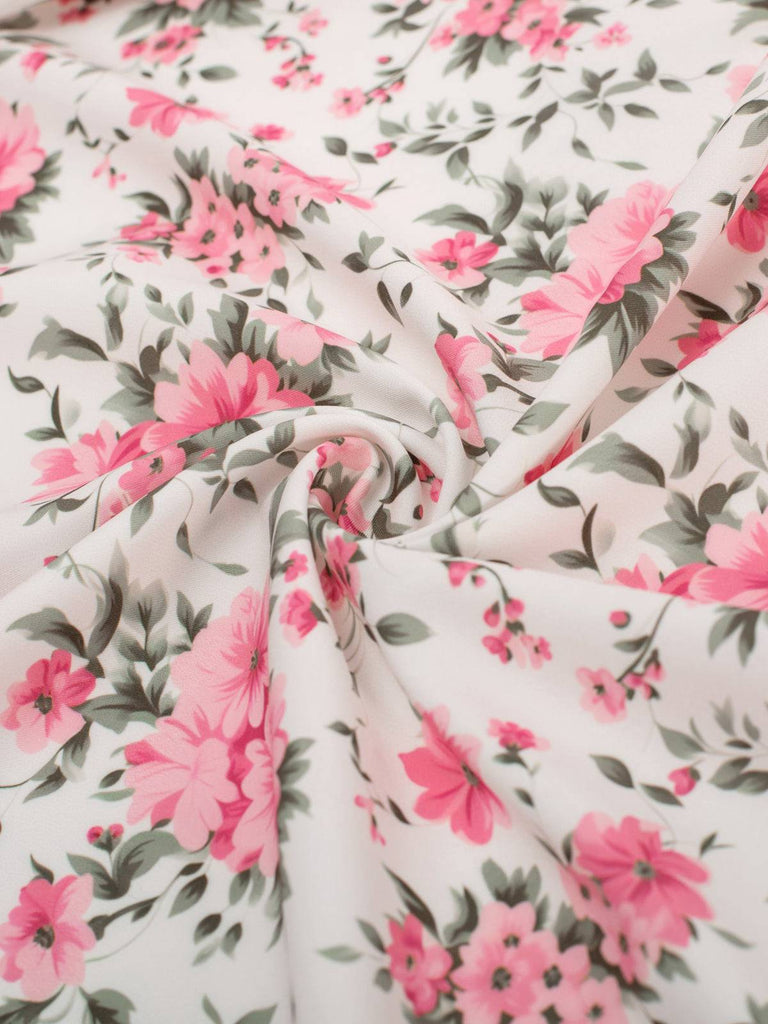 This Pink 1950s Ditsy Floral Smocked Dress wraps her in 1950s elegance, one twirl at a time