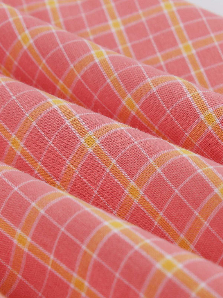 She slips into this Pink 1950s Plaid Buttoned Lapel Belted Dress and suddenly it's a 1950s daydream