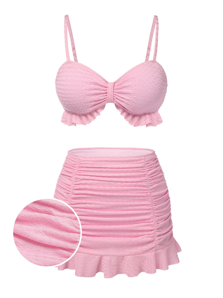 She's wearing Pink 1950s Spaghetti Strap Ruffle Solid Swimsuit and the whole beach remembers the 1950s