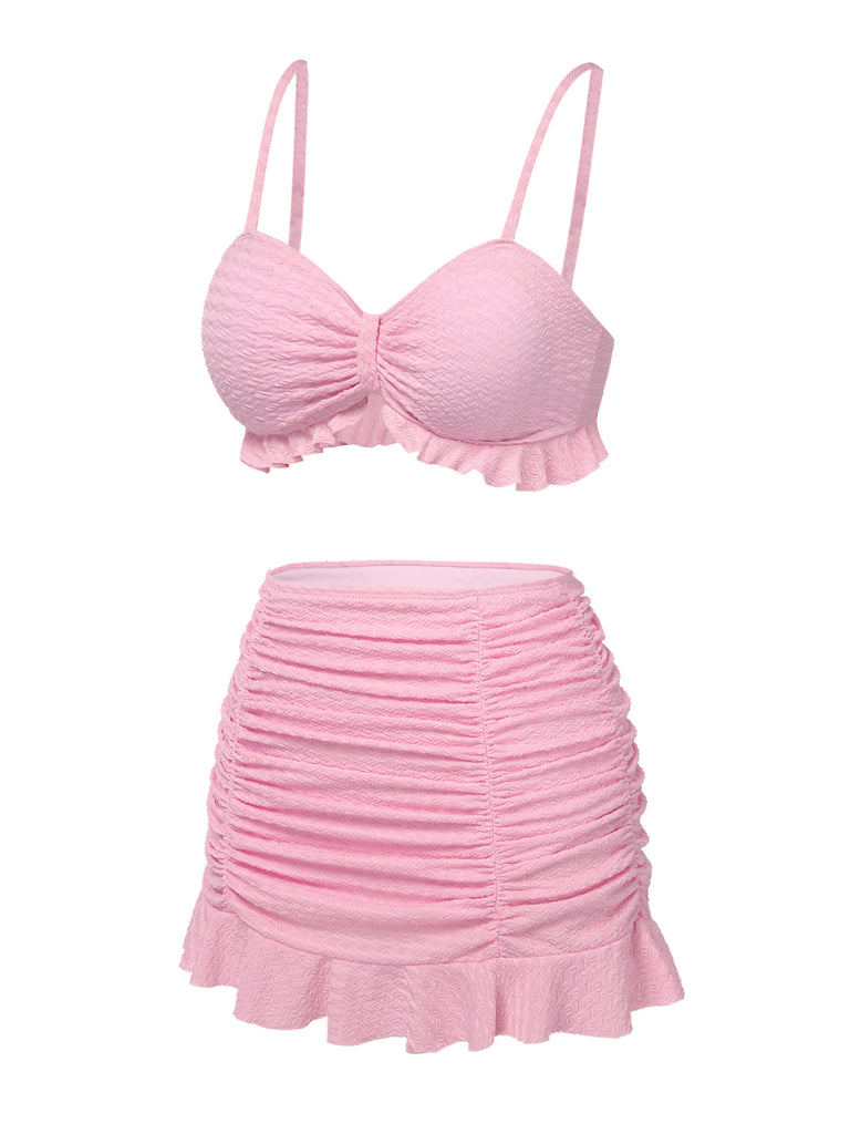 This Pink 1950s Spaghetti Strap Ruffle Solid Swimsuit carries 1950s vacation dreams in every stitch
