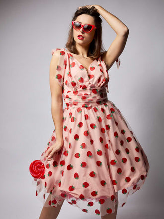She slips into this Pink 1950s Strawberry Mesh Swing Dress and suddenly it's a 1950s daydream