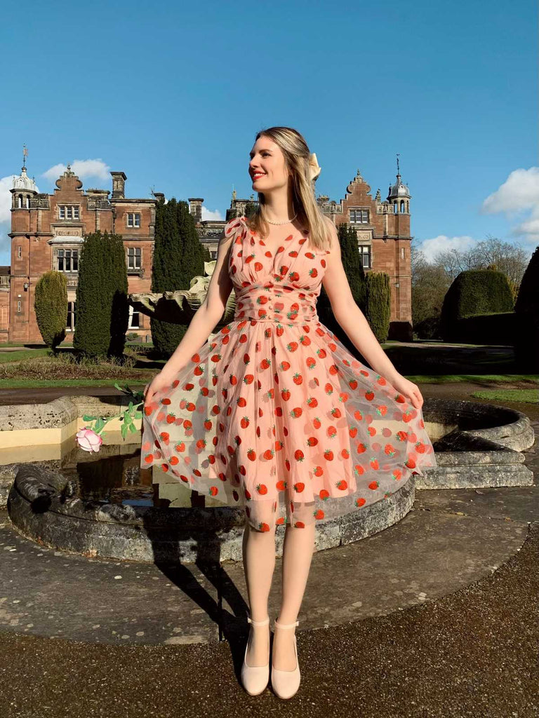 She slips into this Pink 1950s Strawberry Mesh Swing Dress and suddenly it's a 1950s daydream