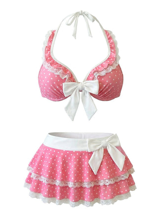 Pink polka dot bikini set with white bows on a white background