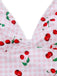 Close-up of a bikini top with cherry pattern on a pink checkered background