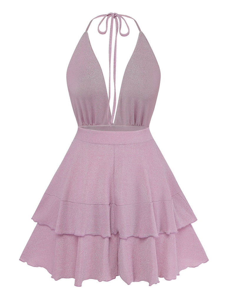 Pink halter neck dress with ruffled layers on a white background