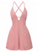 Pink romper with criss-cross straps on a white background