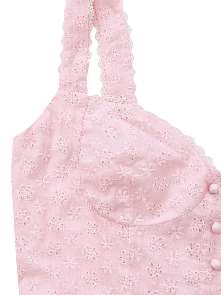Pink baby romper with floral embroidery on a white background