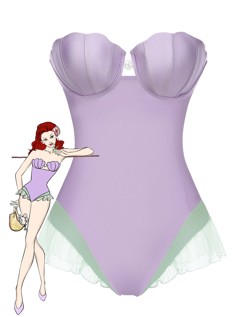 She's wearing Purple 1970s Shell Mermaid Bandeau One-Piece Swimsuit and the whole beach remembers the 1970s