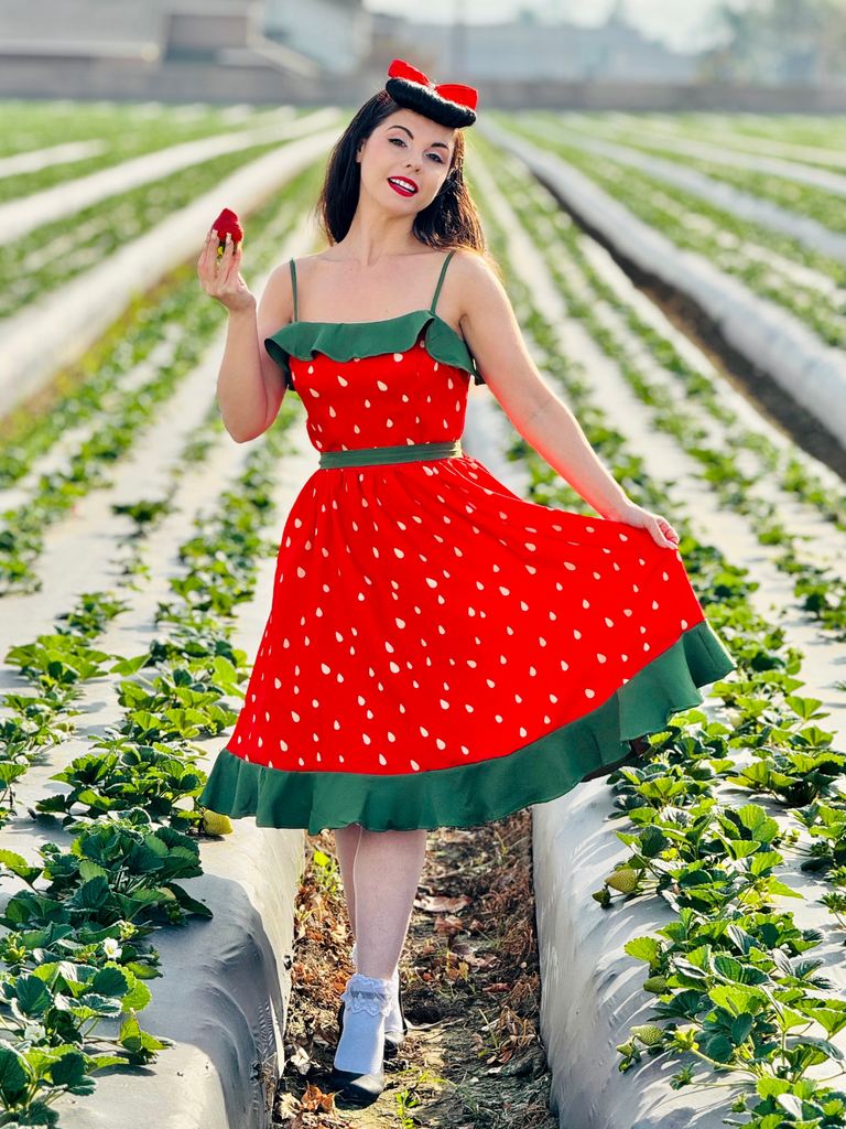 She slips into this Red 1950s Strawberry Ruffle Belt Dress and suddenly it's a 1950s daydream