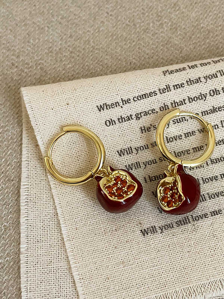 She adds this Red Pomegranate Charm Earrings and suddenly it's vintage perfection
