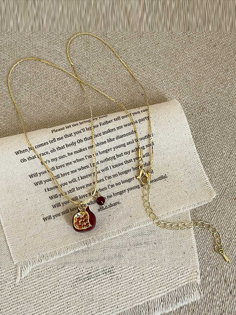 She adds this Red Pomegranate Pendant Necklace and suddenly it's vintage perfection