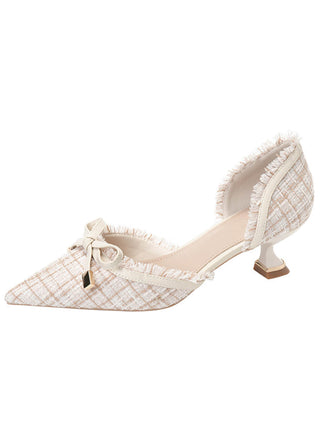 She finds her 1950s story in this Retro Tweed Bow Kitten Pointed Heels