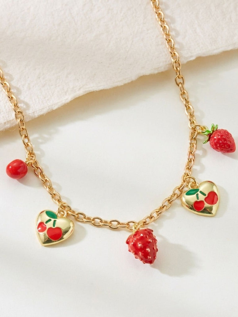 Gold necklace with heart-shaped strawberry charms on a white background