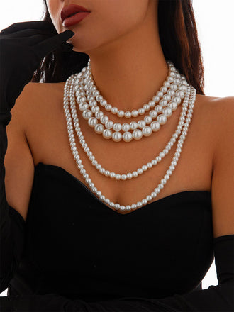 She adds this Vintage Layered Pearl Statement Necklace and suddenly it's 1950s perfection