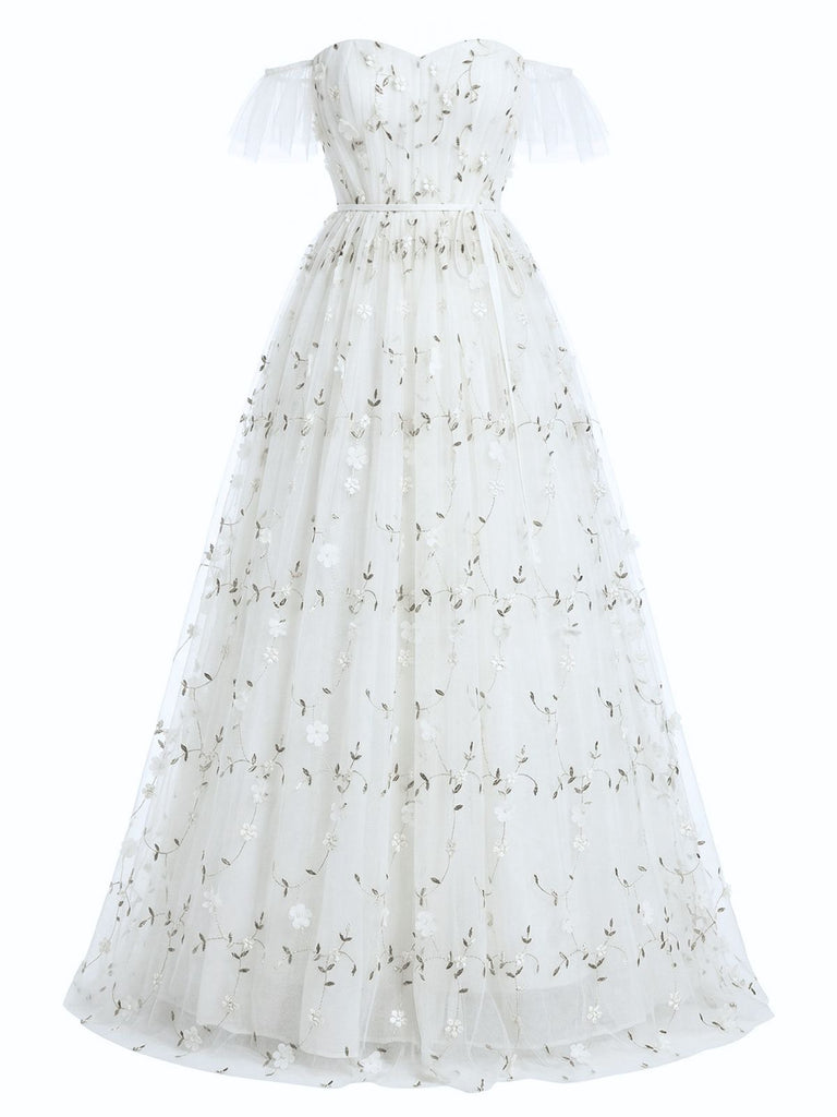White dress with floral embroidery on a white background