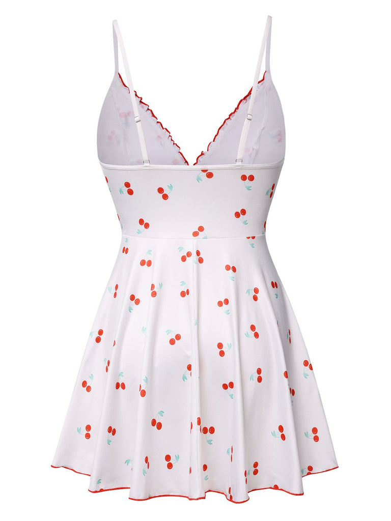 This White 1950s Spaghetti Strap Cherry Bow Sleepwear is 1950s romance against her skin