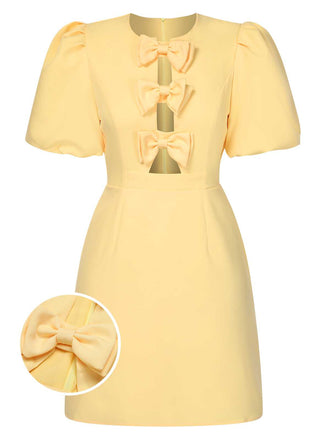 She slips into this Yellow 1960s Bow Puff Sleeve Solid Dress and suddenly it's a 1960s daydream