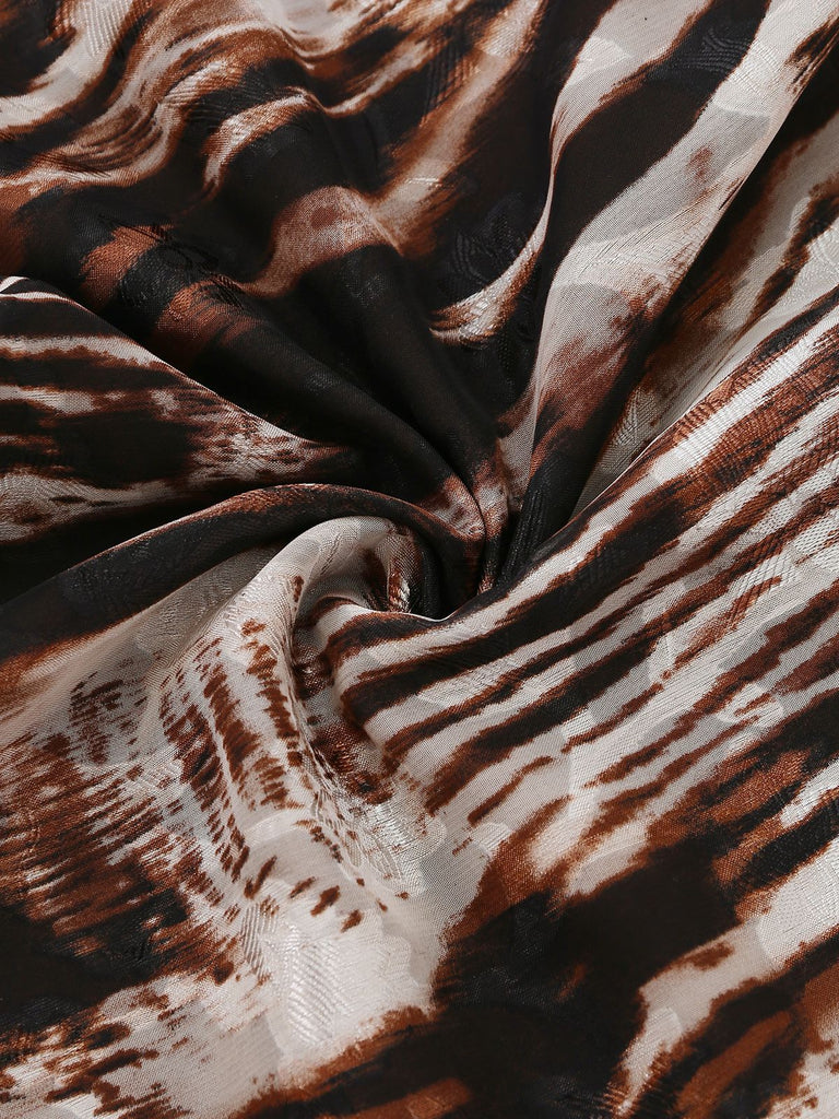 Macro view of the lightweight, silky fabric with a brown and black abstract animal stripe pattern.