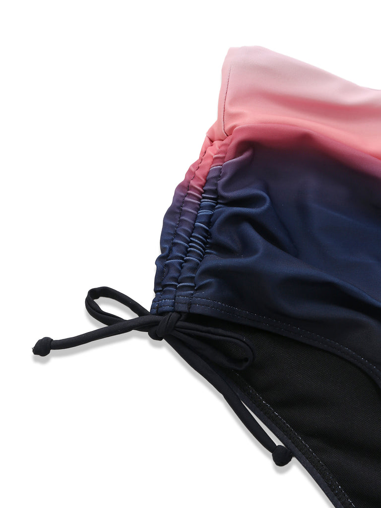 Detailed shot of the side-tie closure and gathered ruching on the high-waisted navy blue bikini bottoms.