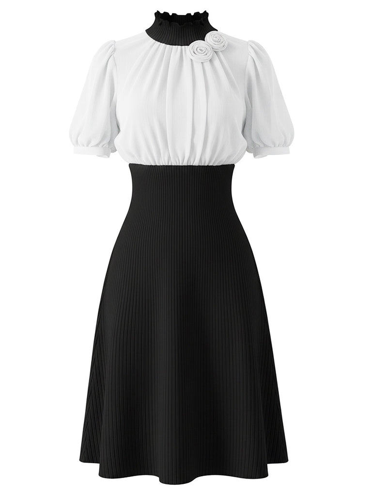 Elegant black 1930s-style ribbed knit dress featuring 3D rose appliques on puff sleeves and a stand collar, perfect for a sophisticated vintage-inspired evening look
