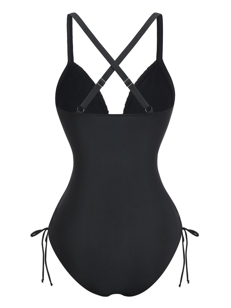 Rear view of the black one-piece swimsuit highlighting the elegant cross-back strap design and full coverage bottom.
