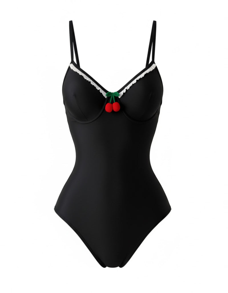 Front studio view of the black pin-up style swimsuit highlighting the contrast trim and cherry accent.