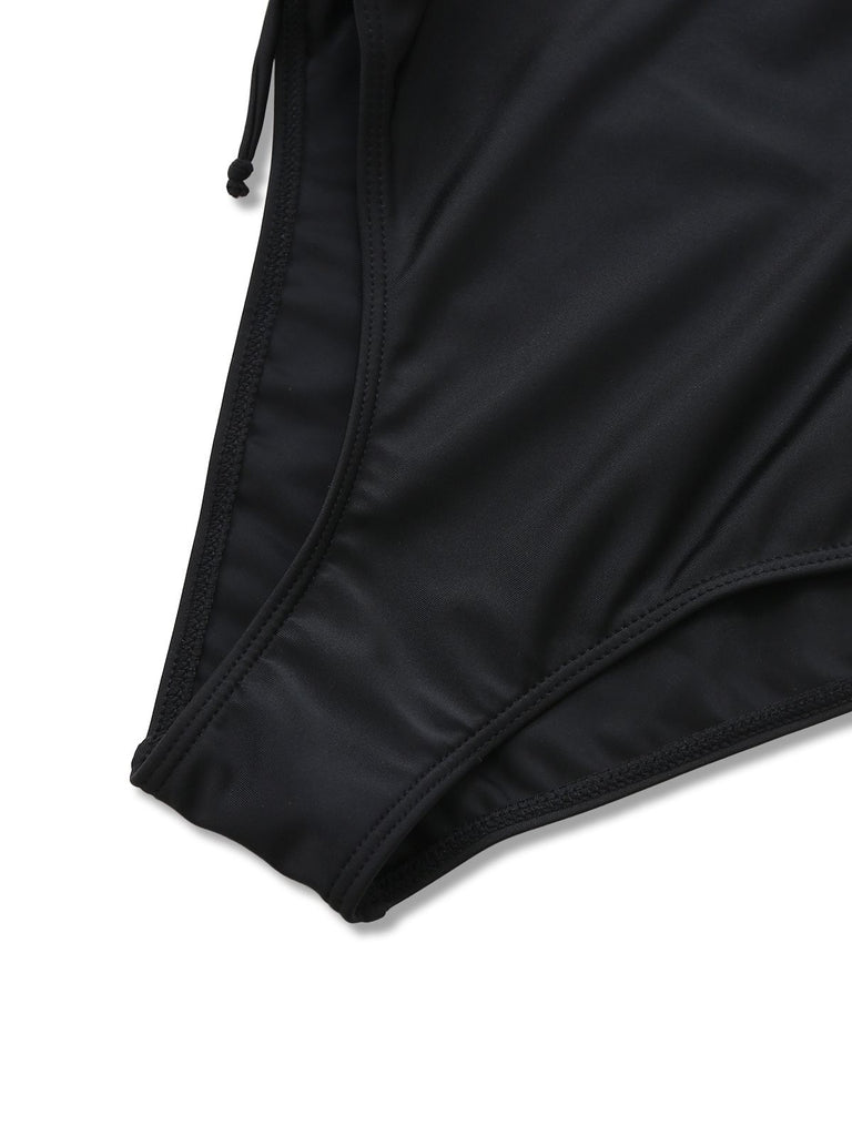 Close-up of the elastic leg opening and high-quality stitching on the black swimwear.