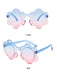 Flower-shaped sunglasses with blue-to-pink gradient lenses and transparent blue frames, perfect for a vibrant summer look.
