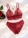The burgundy lace lingerie set displayed on a white satin cloth with a rose, perfect for romantic gift ideas.
