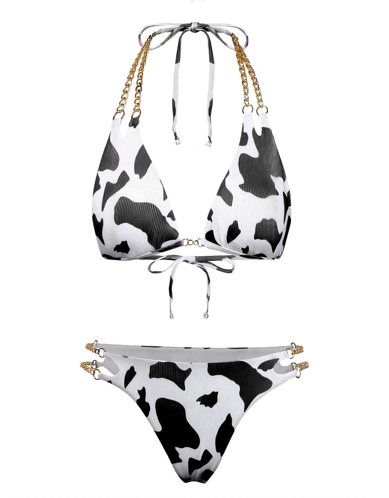 A triangle bikini set featuring a black and white cow print with decorative gold chain-link straps on both the top and high-cut bottoms.
