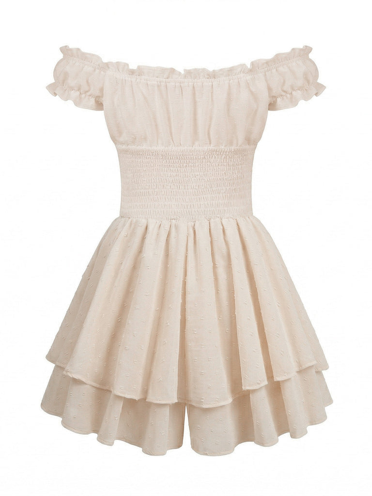 Back view of the cream smocked mini dress highlighting the tiered ruffle skirt and stretchy fit.